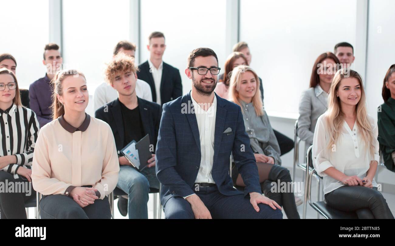 group of diverse young people sitting in a conference room Stock Photo ...