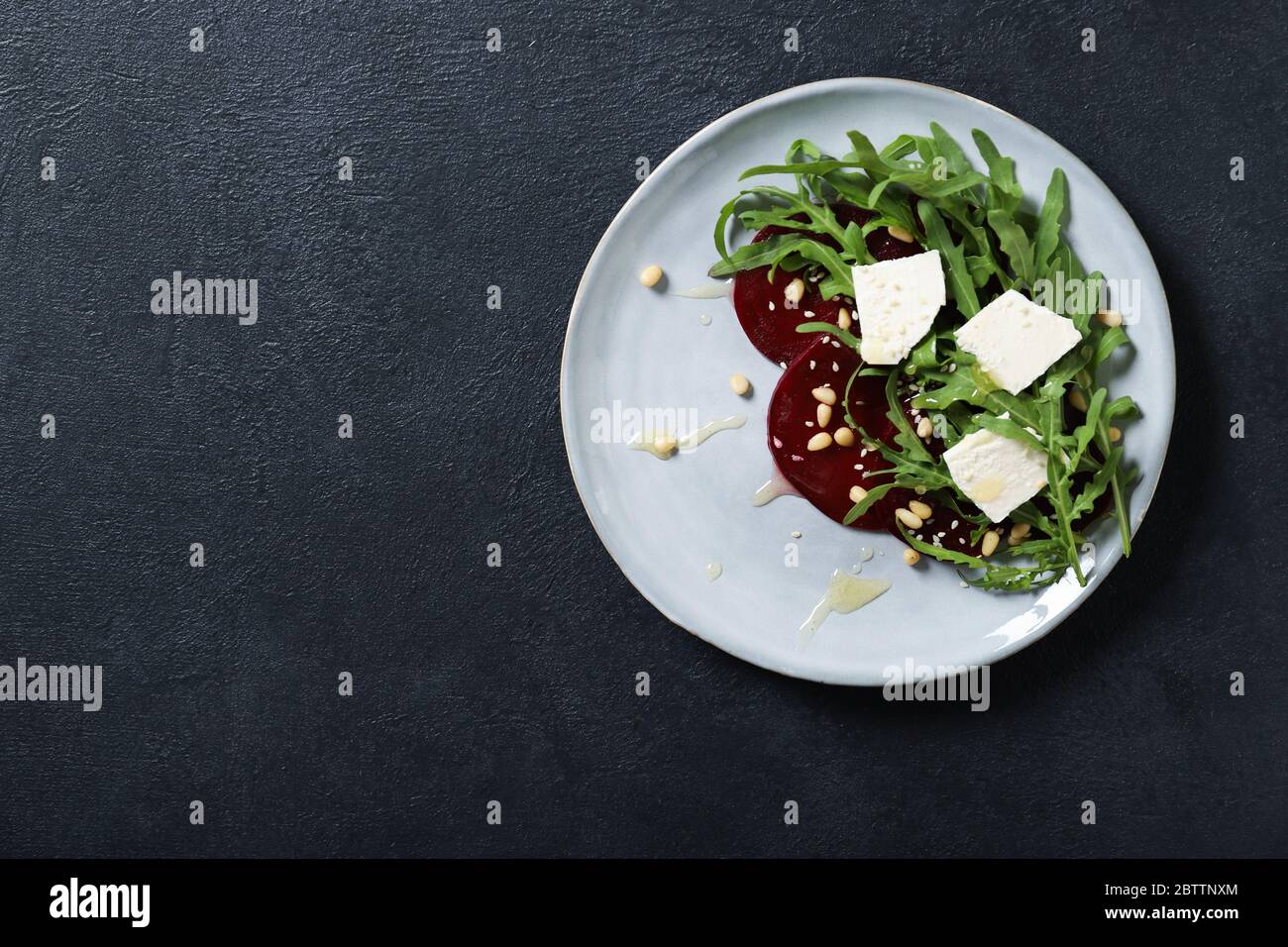 Tasty salad with beetroot and feta. On a black background Stock Photo