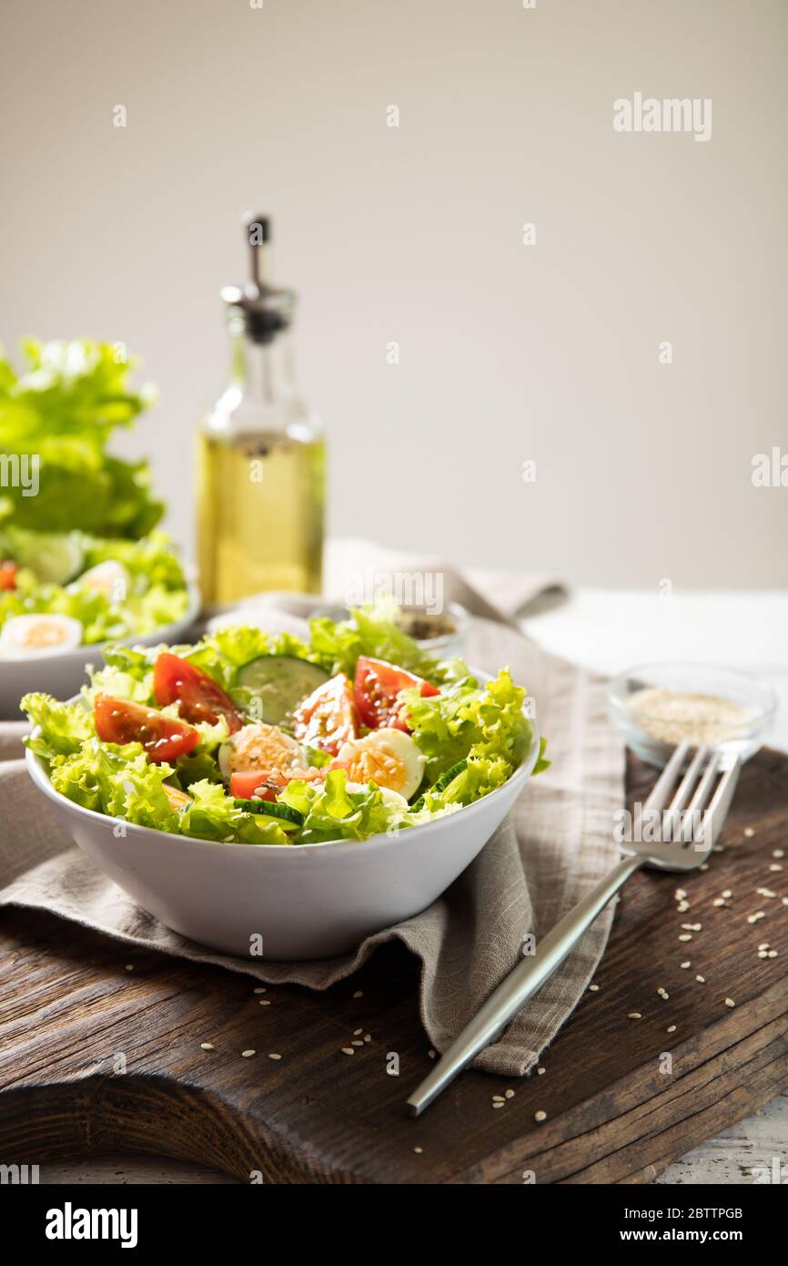 Tasty salad of fresh vegetables with quail eggs. Diet concept Stock Photo