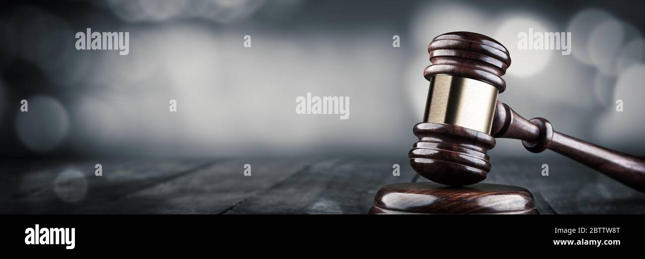 Gavel And Block On Wooden Desk With Bokeh Background - Law And Justice / Auction Concept Stock Photo