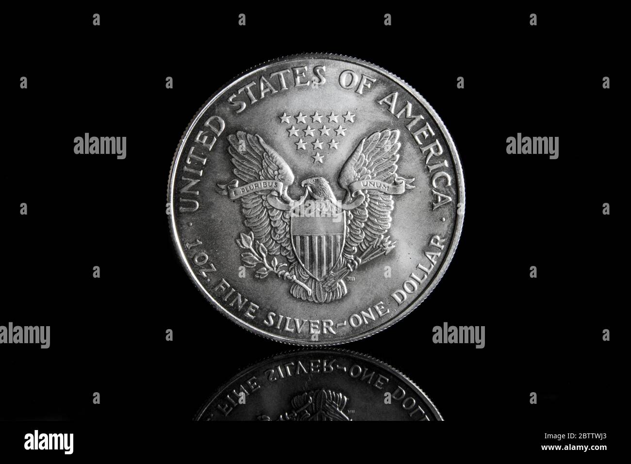 Front of an American Silver Eagle 1 Ounce Fine Silver Bullion Coin against a back background with reflection. Stock Photo