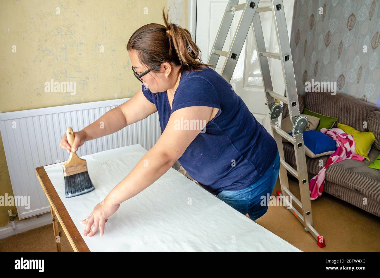 Woman Knead Glue Wallpapering Pouring Wallpaper Stock Photo 2084173105