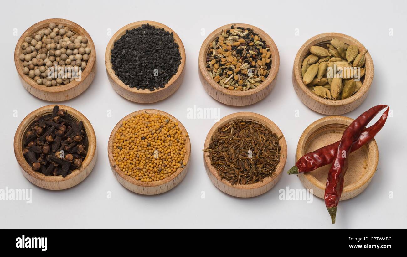 Different type of spices in small wooden bowls on white Background. Stock Photo