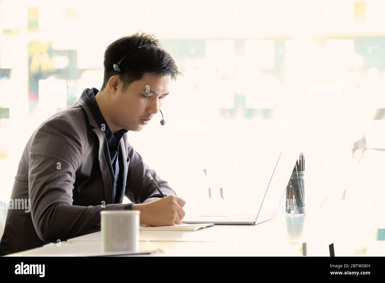 Young asian handsome male customer support phone operator Stock Photo