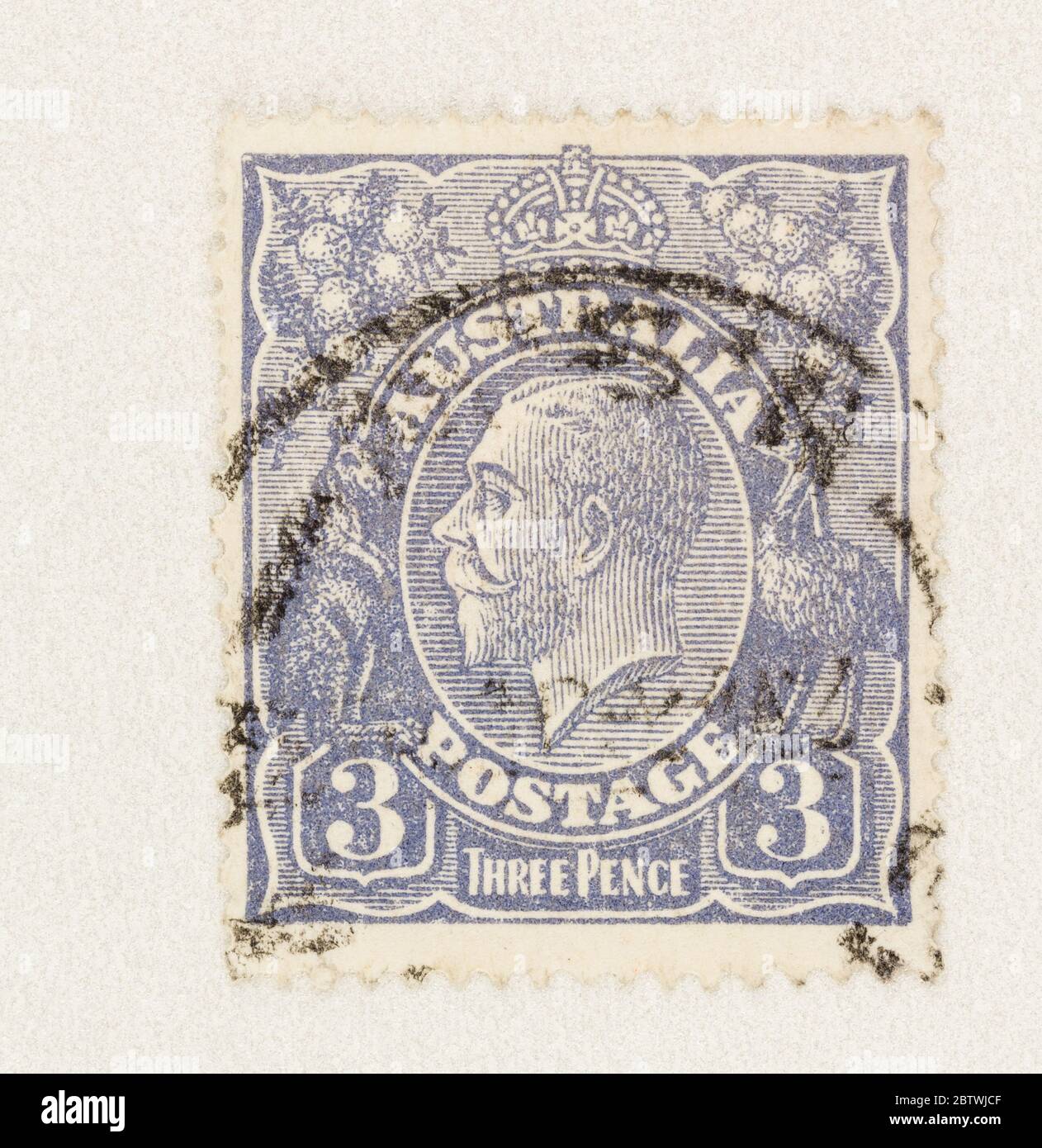 SEATTLE WASHINGTON - May 27, 2020:  King George V in blue on 3 pence Australian postage stamp, with kangaroo and emu. Stock Photo