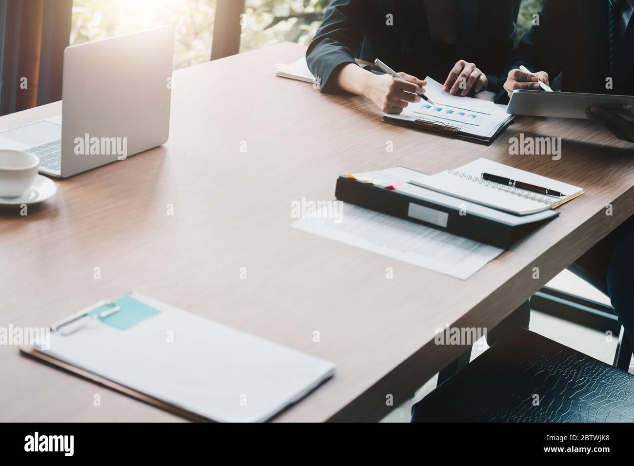 Group of business people busy discussing financial matter during meeting. Corporate Organization Meeting Concept Stock Photo