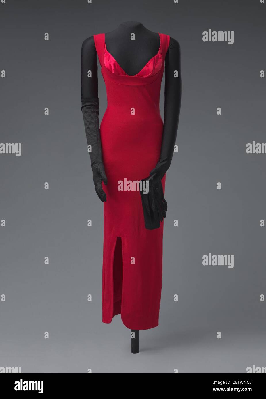 Costume worn by Terry Ellis in Giving Him Something He Can Feel video. A costume worn by Terry Ellis of En Vogue for the music video 'Giving Him Something He Can Feel' (1992) comprised of a red dress (.1), a bra (.2), a pair of elbow-length black gloves (.3), and a pair of black stiletto heels (.4ab).Dress (.1): A red sleeveless dress with an an ank Stock Photo