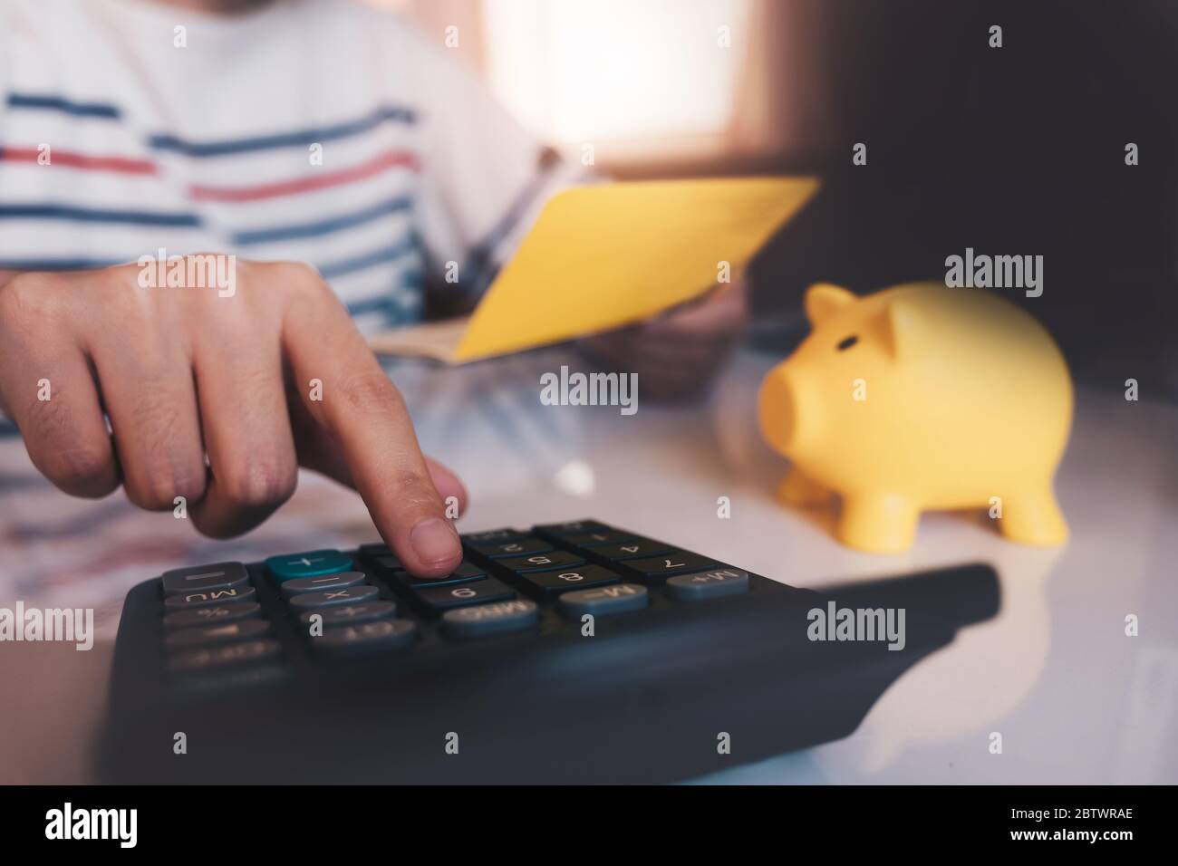 Business hands holding saving account passbook with calculator, account and saving Stock Photo