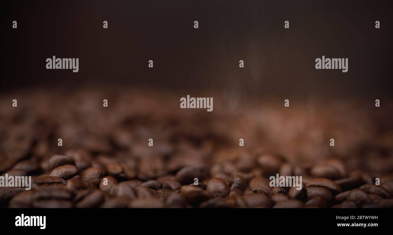 The hot of brown roasted coffee beans on brown background long banner ...