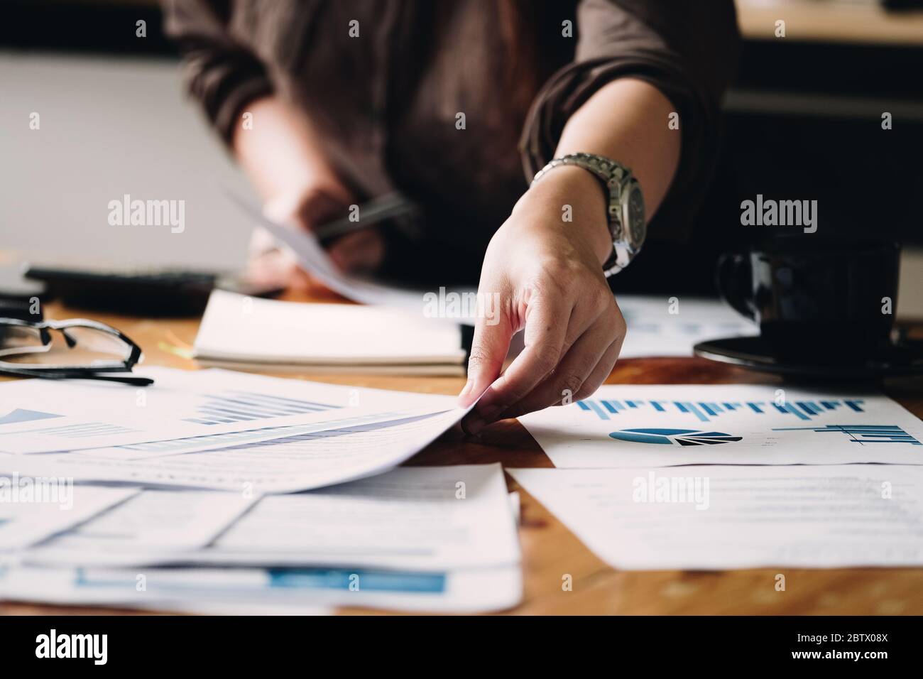 Business woman investment consultant analyzing company annual financial report Stock Photo