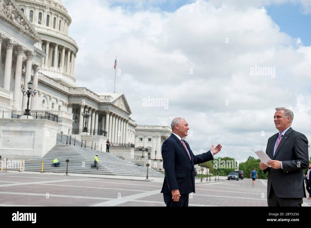 House Minority Leader Rep. Kevin McCarthy (R-Calif., right) chats with House Minority Whip Rep. Steve Scalise (R-LA, left) prior to a media availability to announce that Republican leaders have filed a lawsuit against House Speaker Nancy Pelosi and congressional officials in an effort to block the House of Representatives from using a proxy voting system to allow for remote voting during the coronavirus pandemic, outside of the U.S. Capitol in Washington, DC., Wednesday, May 27, 2020. Credit: Rod Lamkey/CNP | usage worldwide Stock Photo