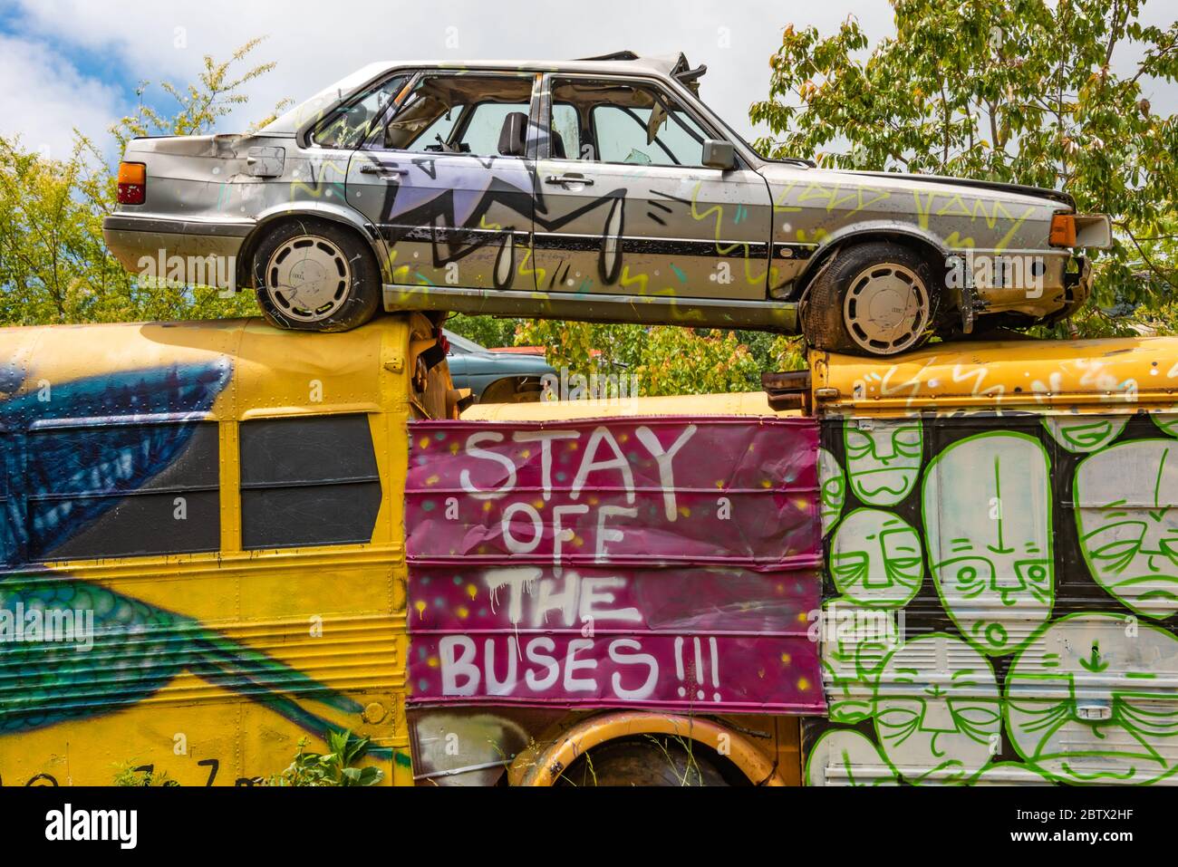 Painted vehicles at the School Bus Graveyard in Alto, Georgia. (USA) Stock Photo