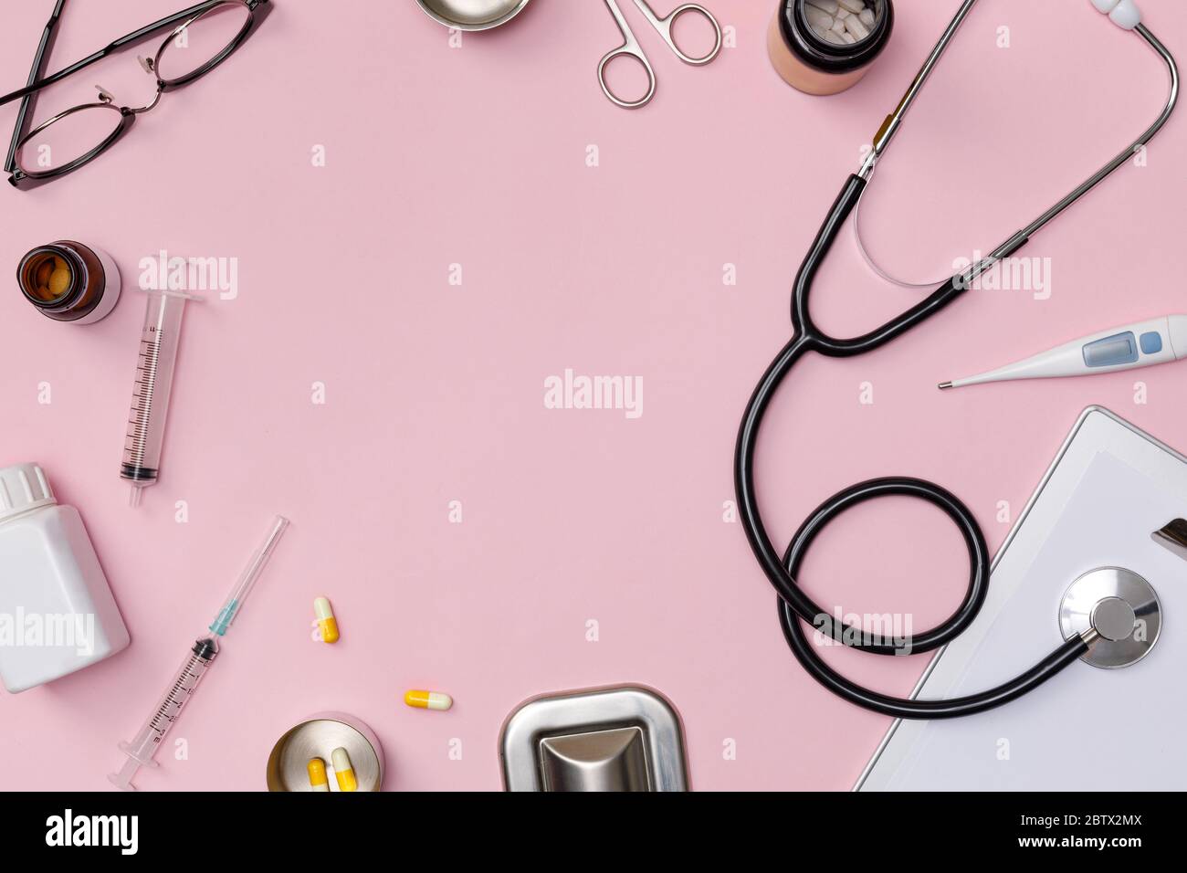 Creative flatlay of doctor medical equipment pink table with stethoscope, medical documents, thermometer, syringe and pills, Health care concept, Top Stock Photo