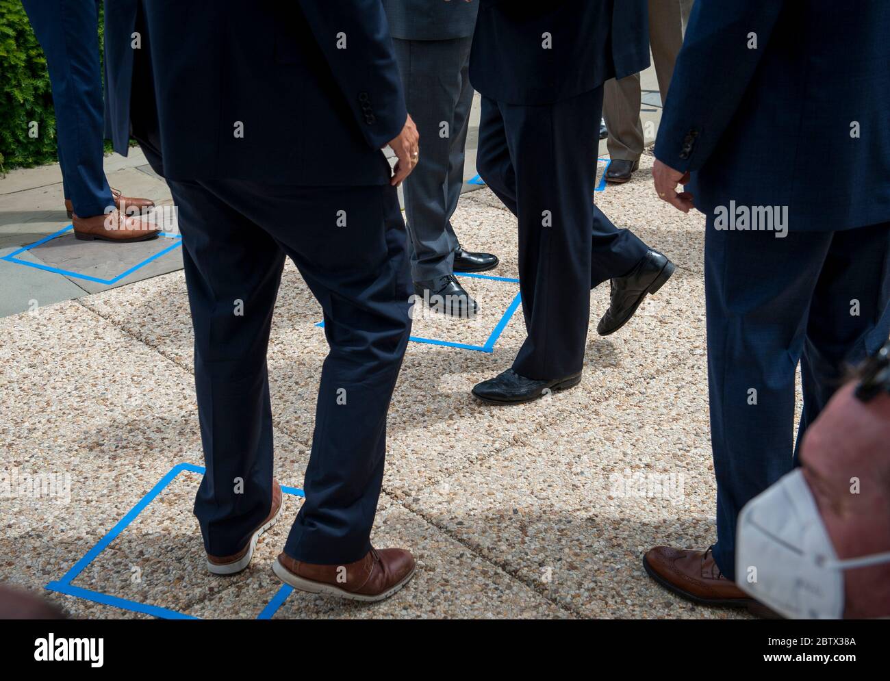 Republican members of Congress arrive and stand outside of the safe distancing squares identified on the pavement, prior to House Minority Leader Rep. Kevin McCarthy's (R-Calif.) press conference with House Minority Whip Rep. Steve Scalise (R-LA), House GOP Conference Chairwoman Liz Cheney (R-WY) and others, to announce that Republican leaders have filed a lawsuit against House Speaker Nancy Pelosi and congressional officials in an effort to block the House of Representatives from using a proxy voting system to allow for remote voting during the coronavirus pandemic, outside of the U.S. Capito Stock Photo