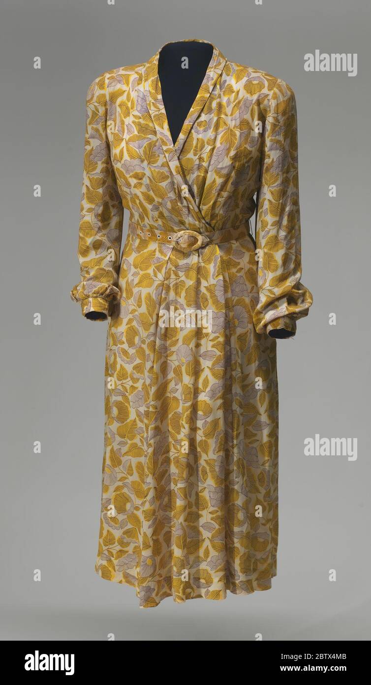 Dress sewn by Rosa Parks. This dress (a) is a wrap style made from a plain weave viscose fabric with a printed design of dark brown and yellow flowers and leaves. The wrap effect is achieved by crossing the front bodice at the waist seam and gathered fabric on the proper left side of the waist. Stock Photo