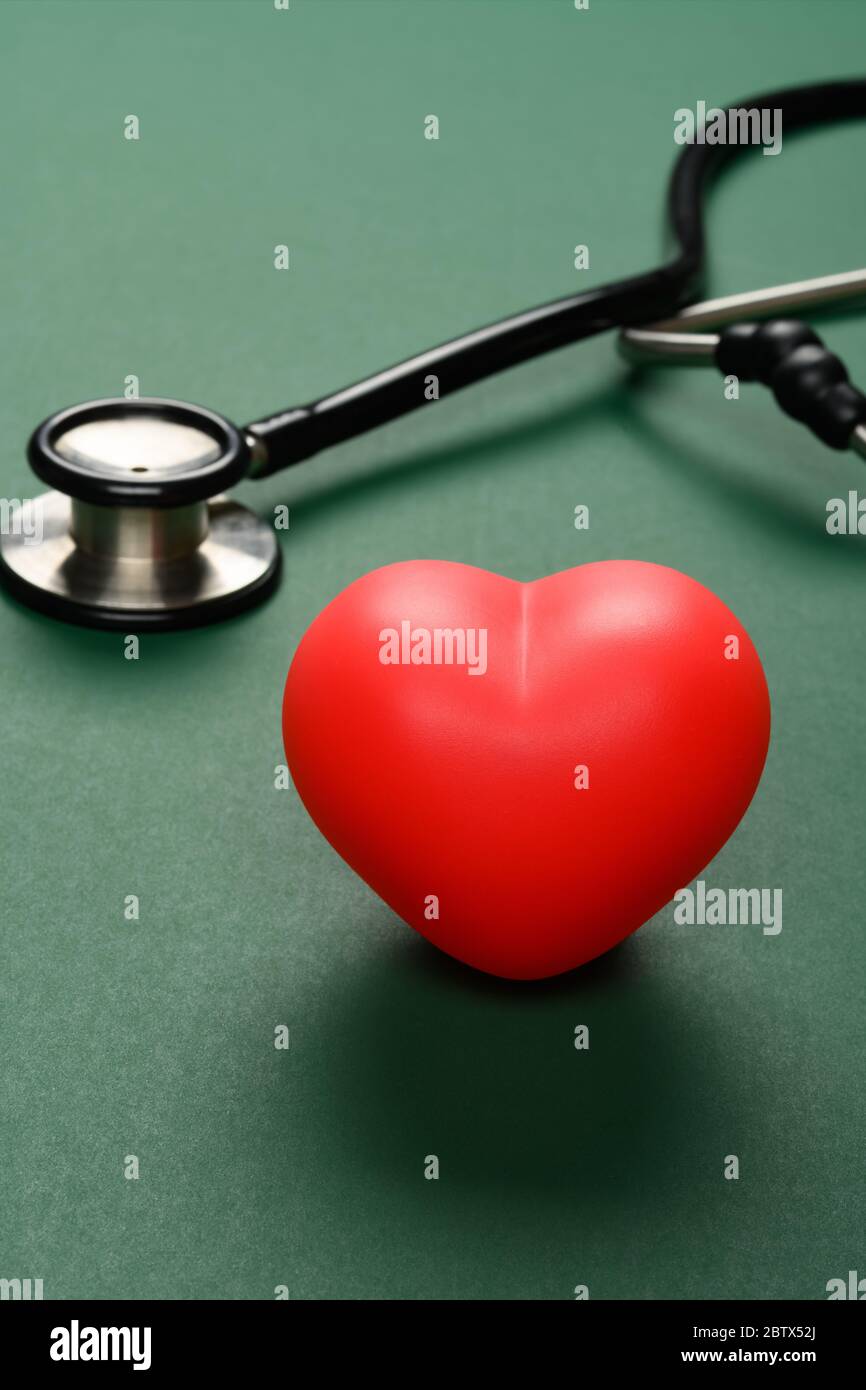 heart and stethoscope on a green background vertical composition Stock ...