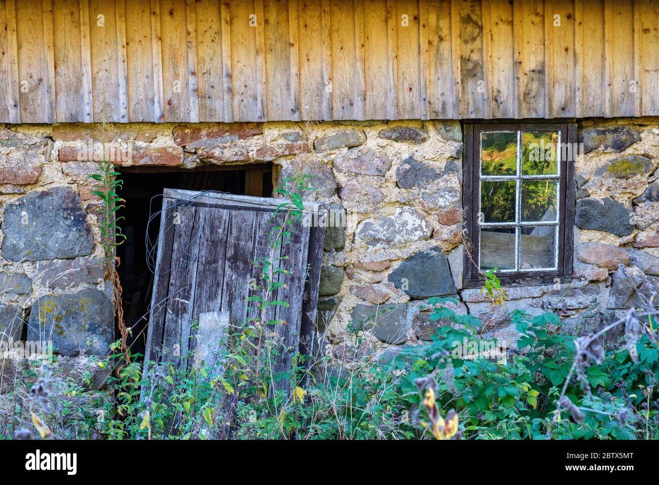Old abandoned house with a broken door Stock Photo