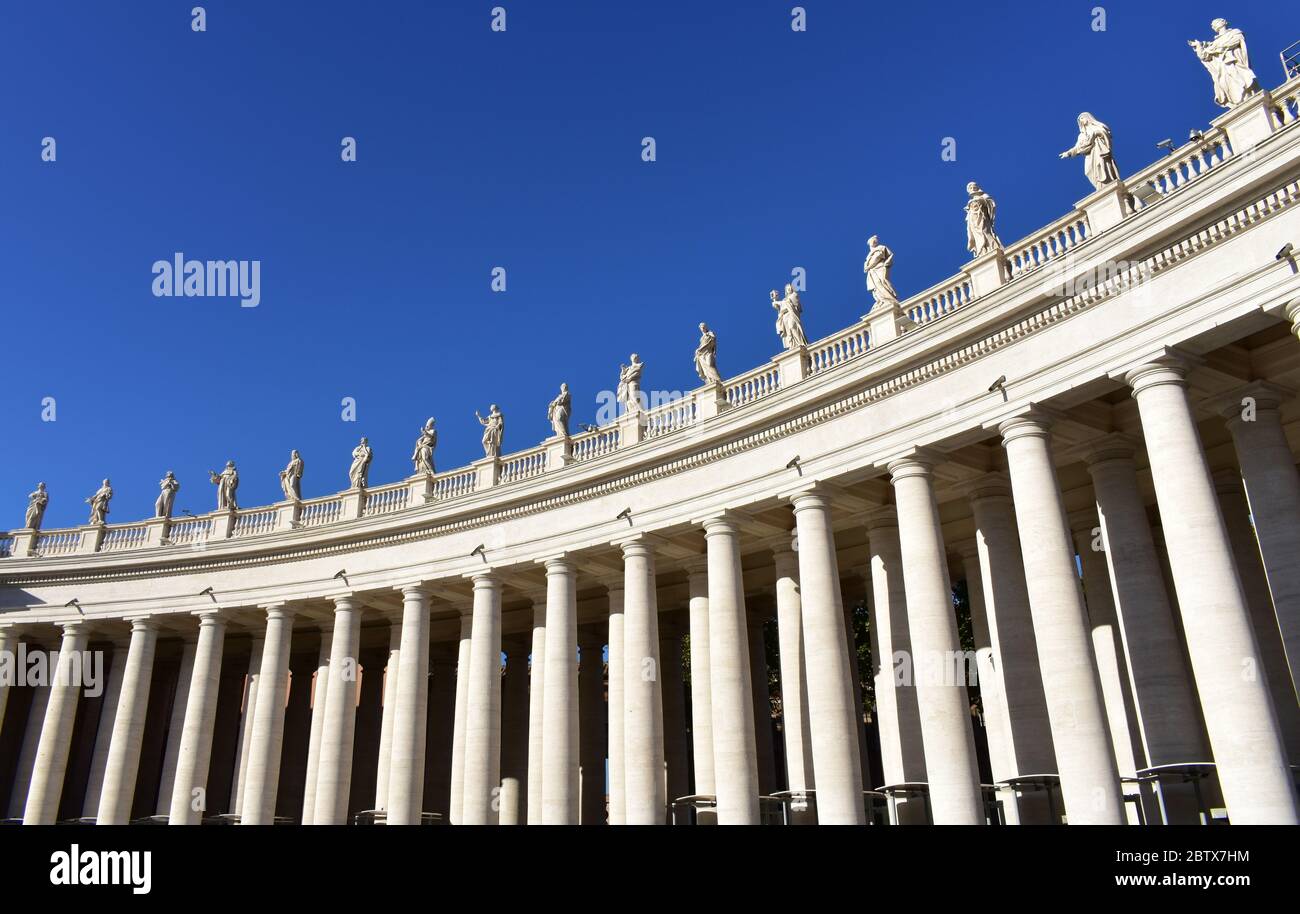Bernini’s Colonnade and statues at St. Peter’s Square with blue sky