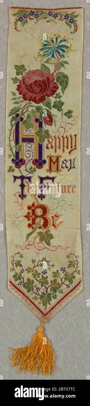 Happy May Thy Future Be. Research in ProgressWhite ribbon with a spray of roses, lilies and curling vines of ivy entwined within the words 'Happy May Thy Future Be.' Finished at the bottom with yellow tassel. Stock Photo