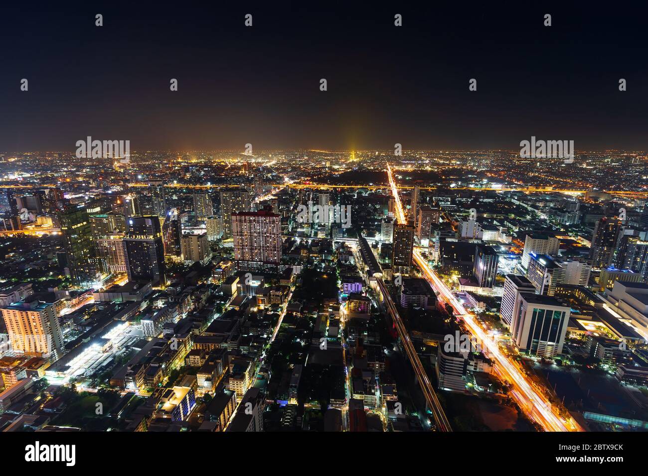 aerial view of Bangkok city downtown and road traffic at night of ...