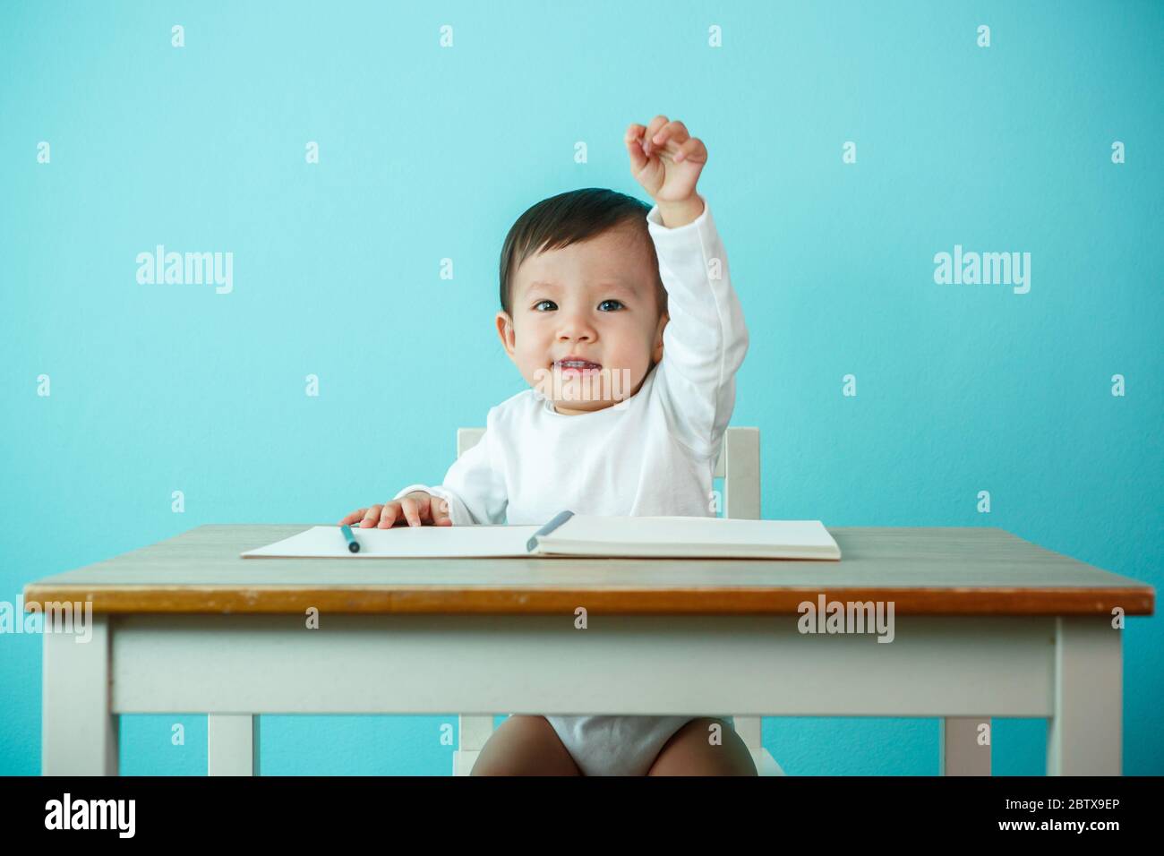Asian baby girl Hand up at the school Stock Photo