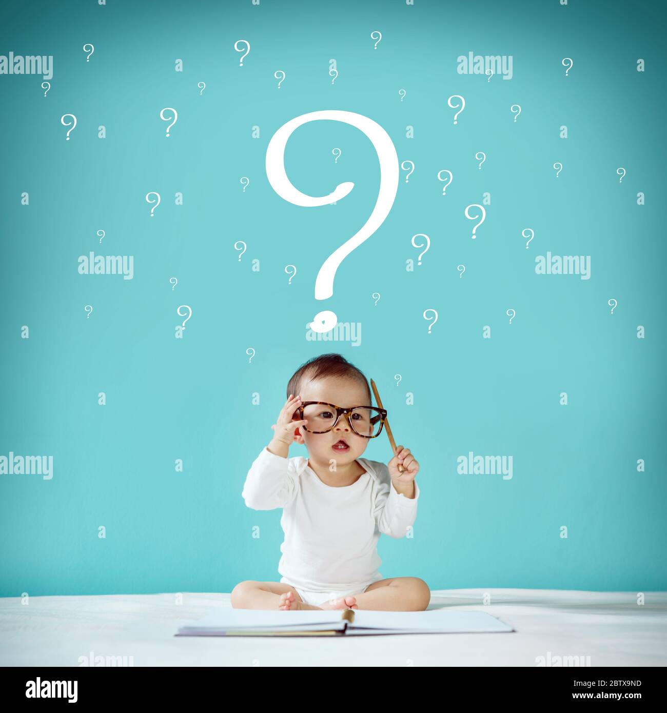 Little baby and blackboard with 'Question Mark' on background, School concept Stock Photo