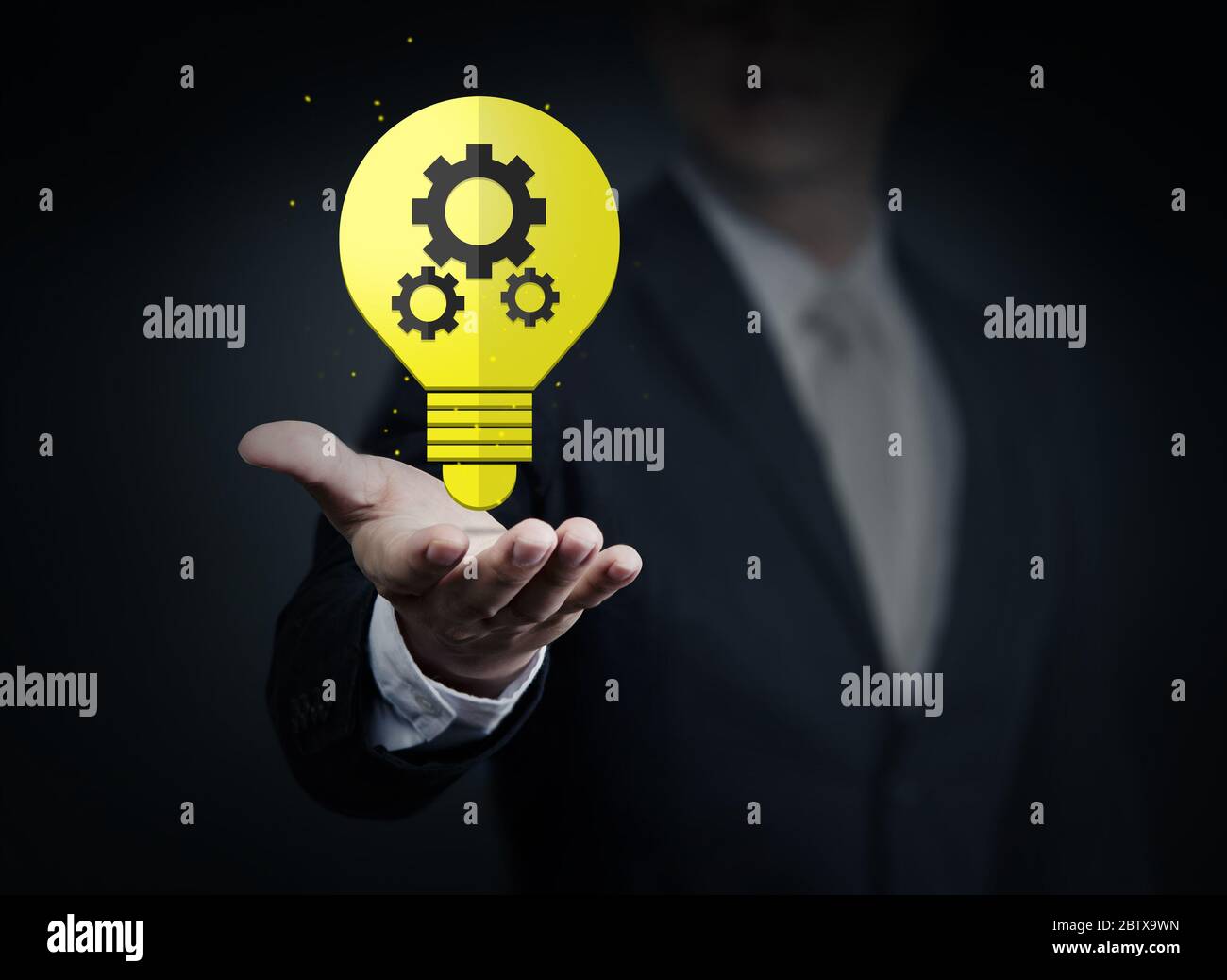 Concept, idea of young businessman with bulb in hand, business collection, studio shot Stock Photo