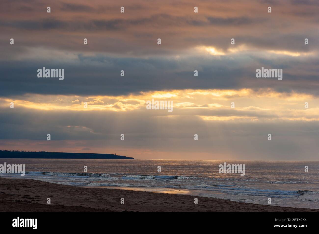 Dramatic sunset at Cavendish Beach, PEI National Park, Canada. Sunbeams