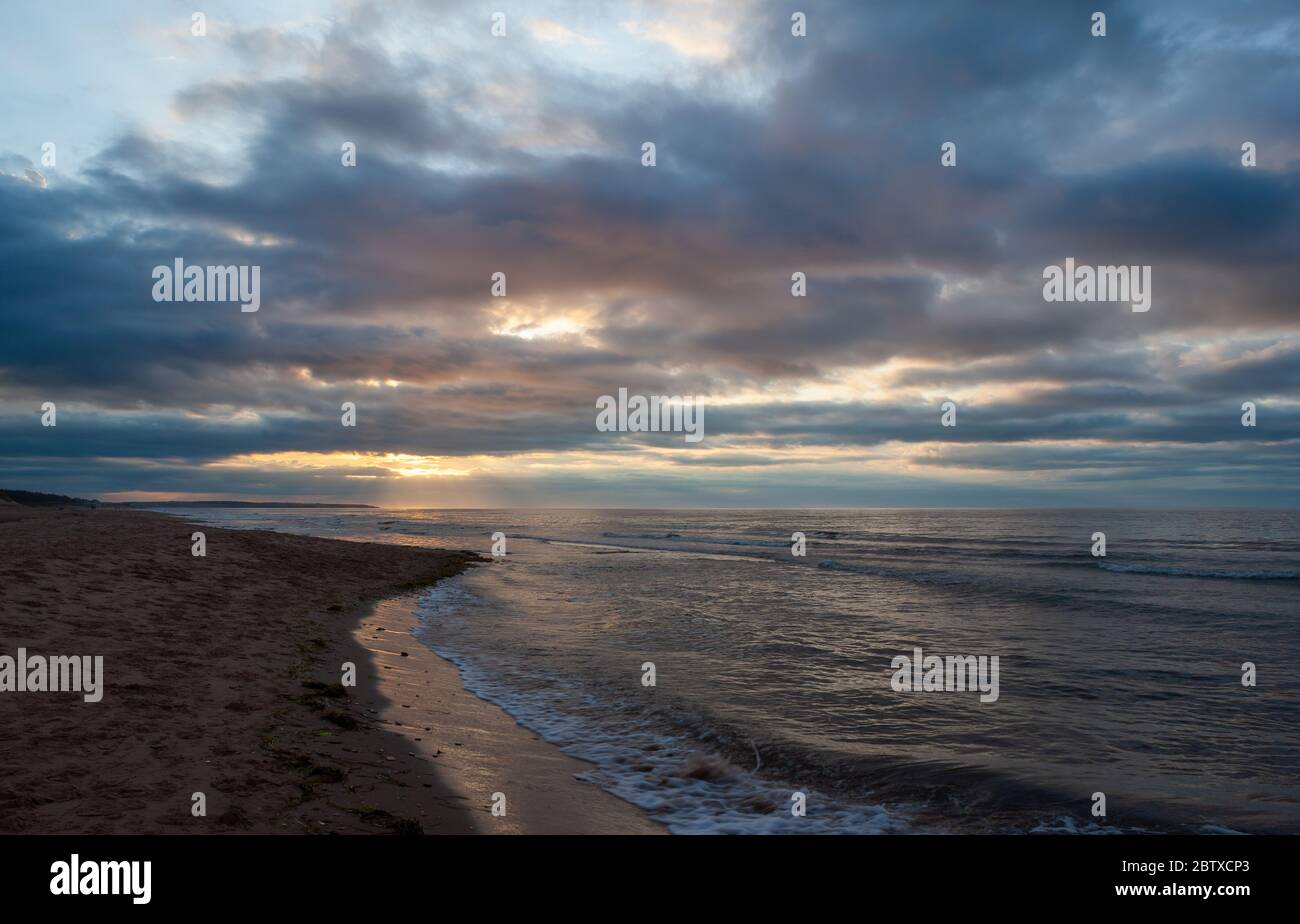 Dramatic sunset at Cavendish Beach, PEI National Park, Canada. Sunbeams