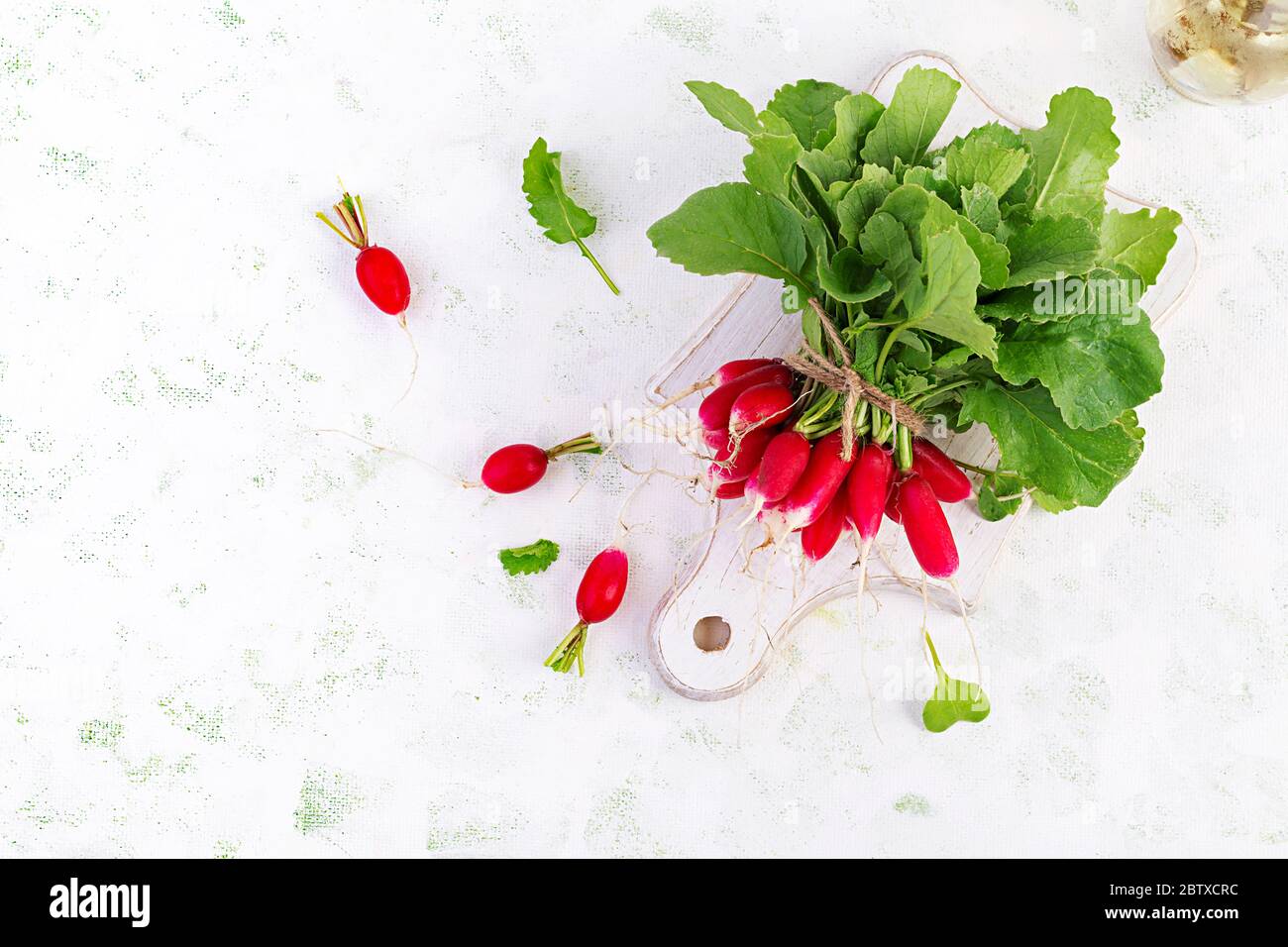 Spring harvest red radish on light background. Bunch of fresh french ...
