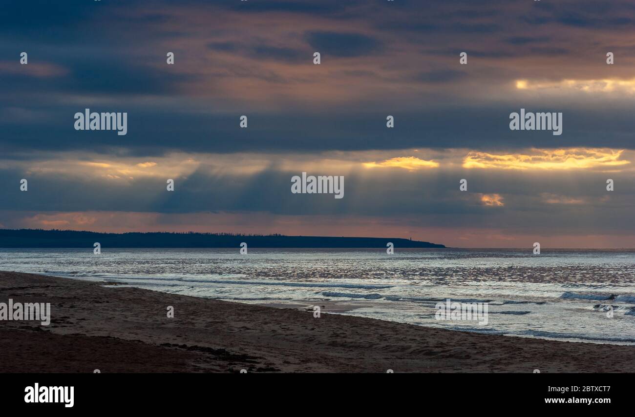 Dramatic sunset at Cavendish Beach, PEI National Park, Canada. Sunbeams