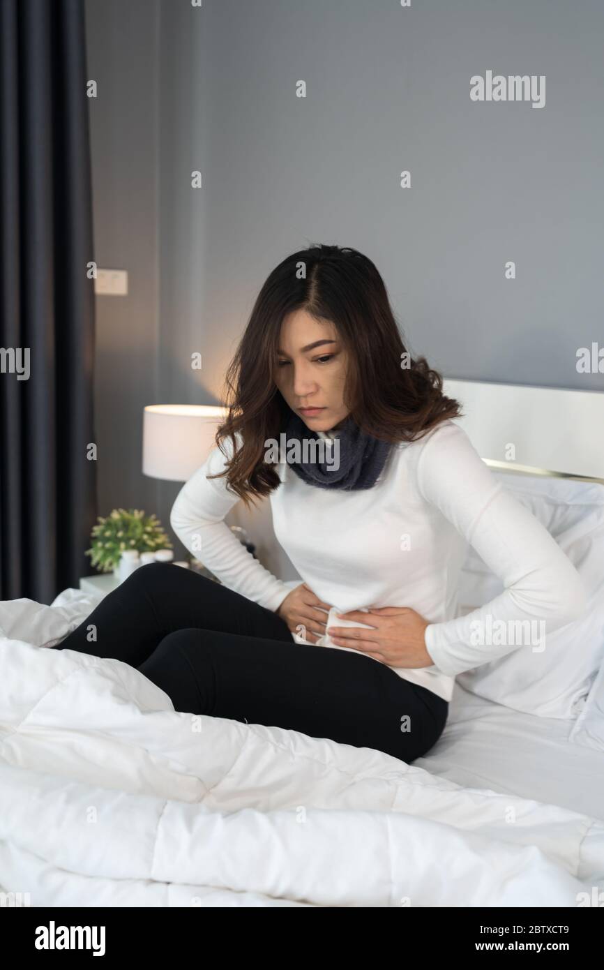 woman with stomach ache in a bed Stock Photo Alamy
