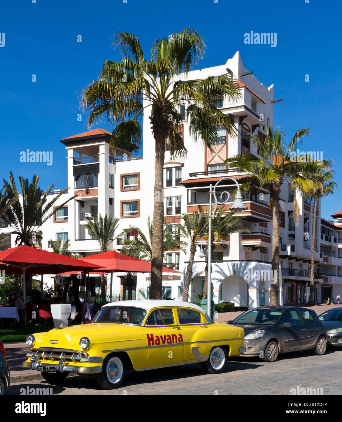 Morocco, Agadir, Marina Quarters, modern luxury residences and a yellow cadillac Stock Photo