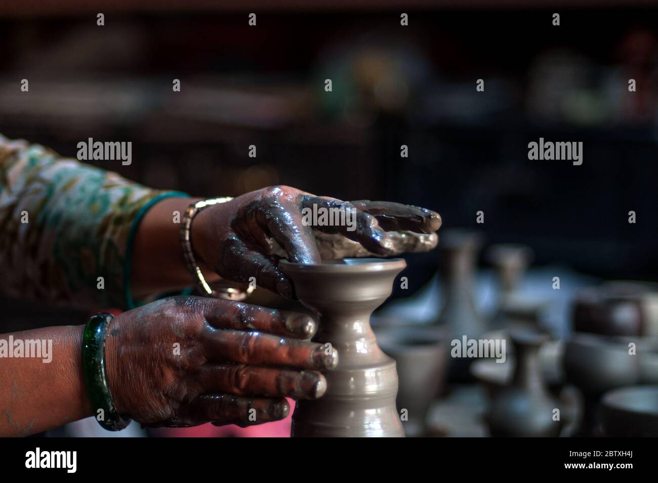 Lady making clay pottery in Bhaktapur pottery square, Nepal Stock Photo