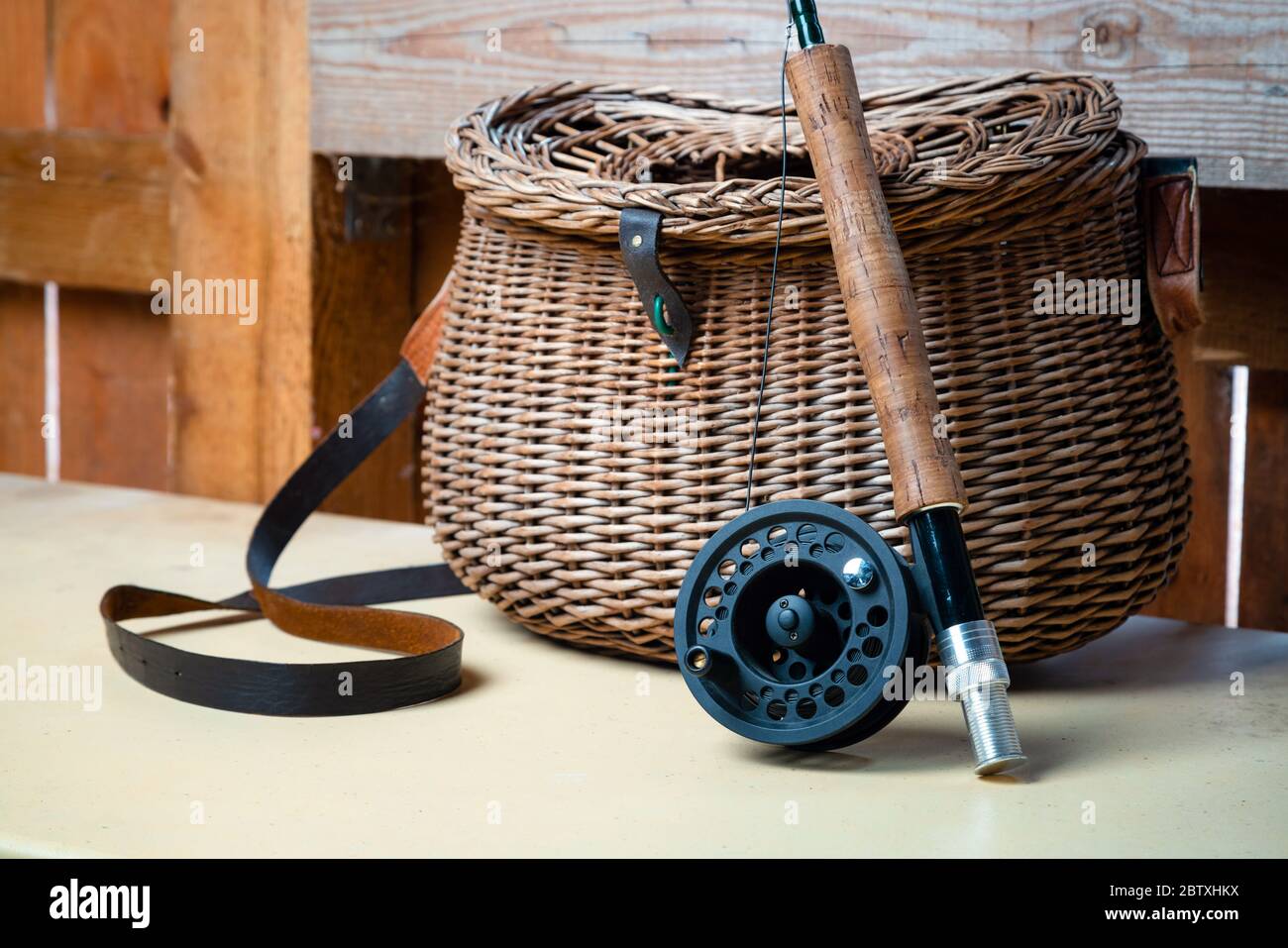 Close up of fly fishing rod with reel next to braided basket. Fly fishing  equipment still life. Nobody Stock Photo - Alamy