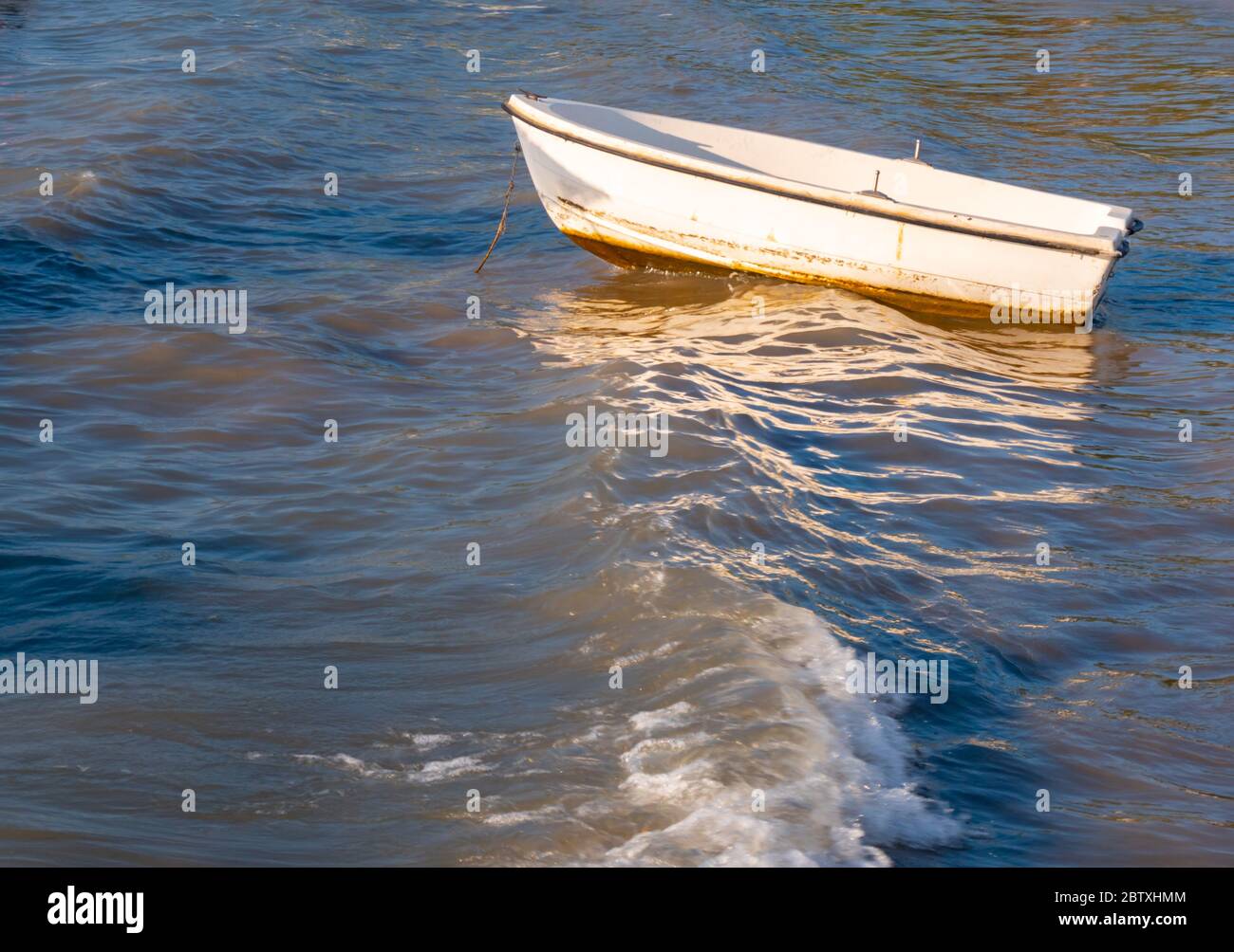 Small fishing boat floating on the sea water. Stock Photo