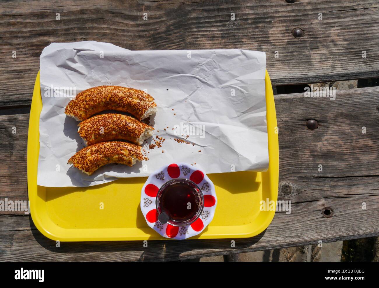 Bagel and glass of Turkish tea on the tray at outside. Stock Photo