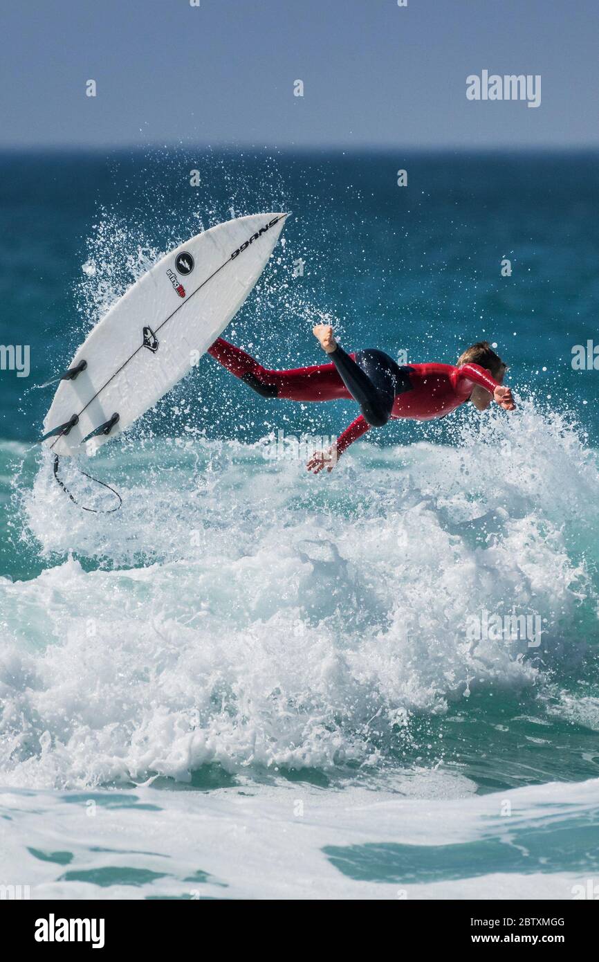 Spectacular action as a young surfer wipes out at Fistral in Newquay in Cornwall. Stock Photo