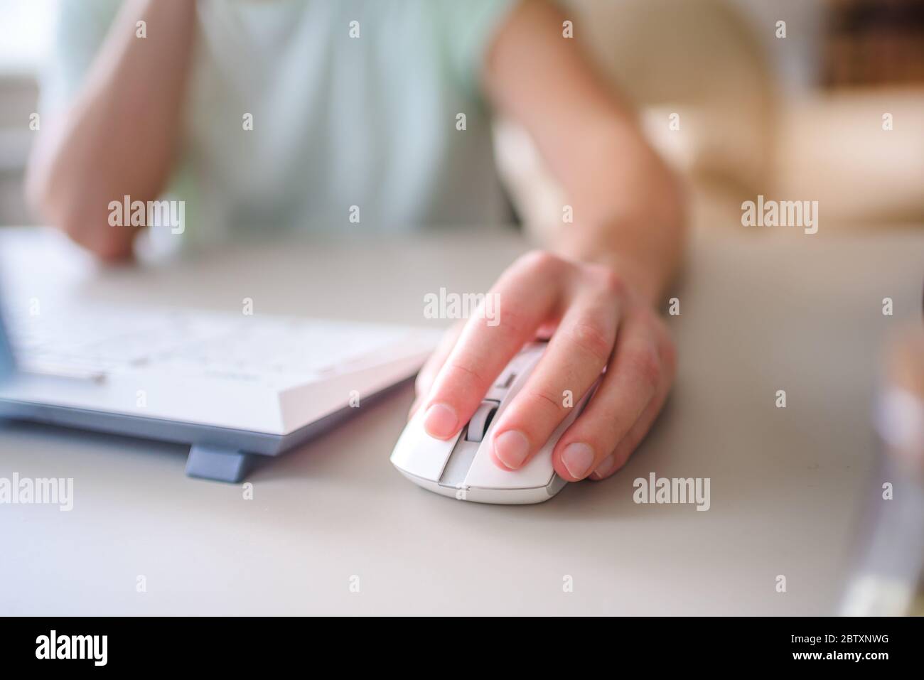 the developer works at computer, uses the mouse Stock Photo