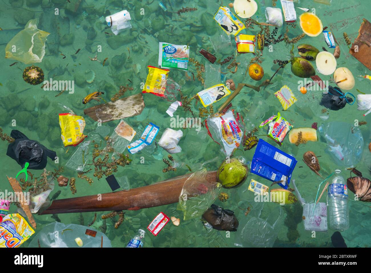 Plastic trash and pollution floating in the sea off the beach at Mabul Island, Sabah, Borneo, Malaysia. Stock Photo