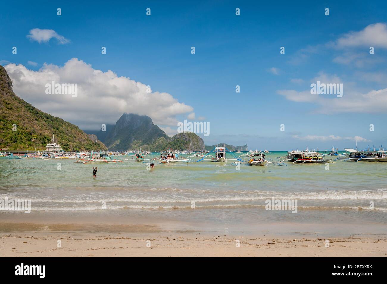 Morning scene at El Nido Beach, El Nido, Palawan, Philippines as the day boats prepare to take tourists out to the islands and beaches. Stock Photo