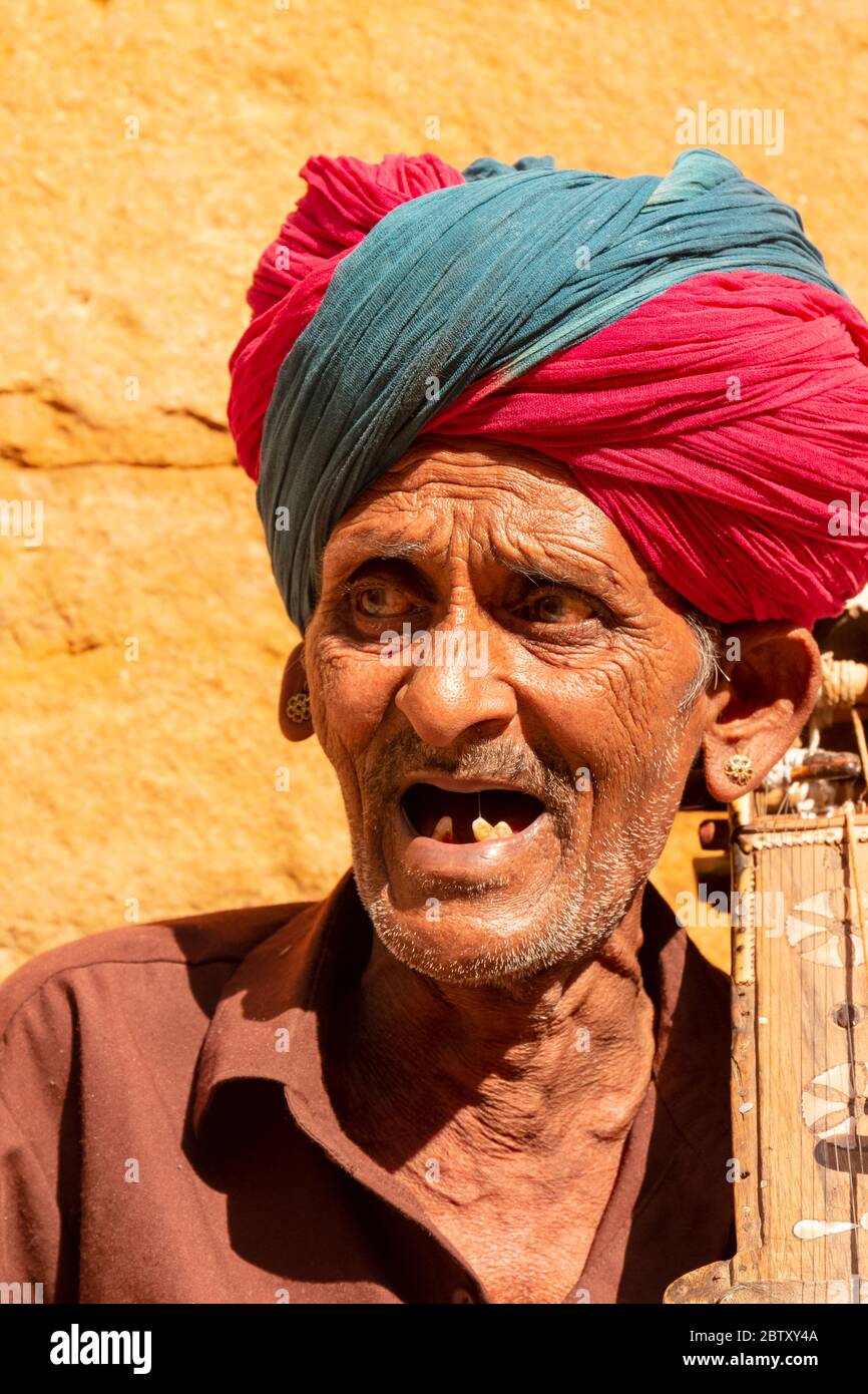 Indian old male musician artist playing indian Violin at Jaisalmer Fort