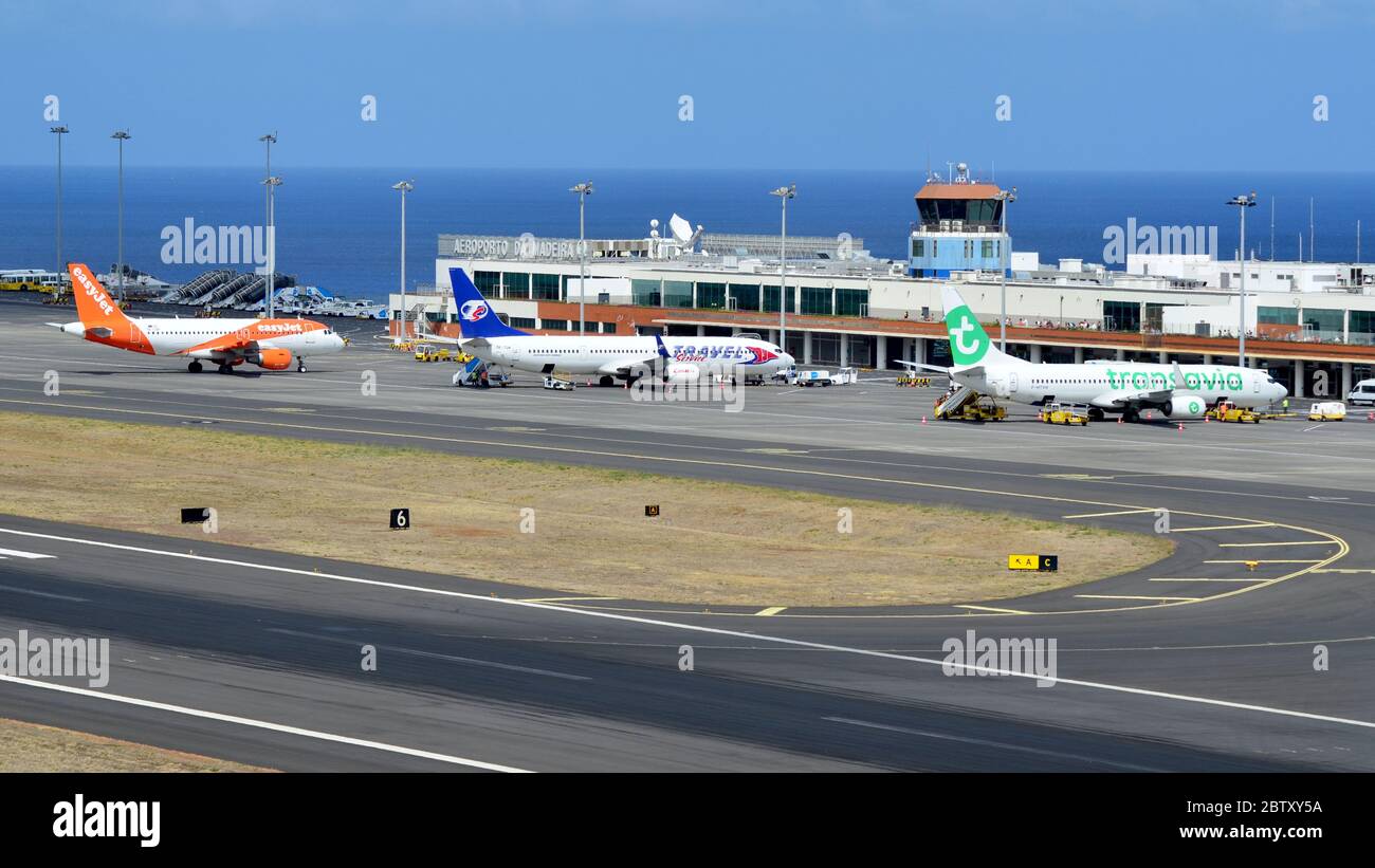 A photograph showing the view of the airport at Funchal Airport, complete with three aircraft of different budget airlines Stock Photo