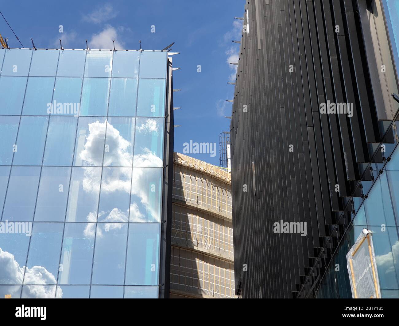 Clouds are reflecting on the modern office building Stock Photo - Alamy