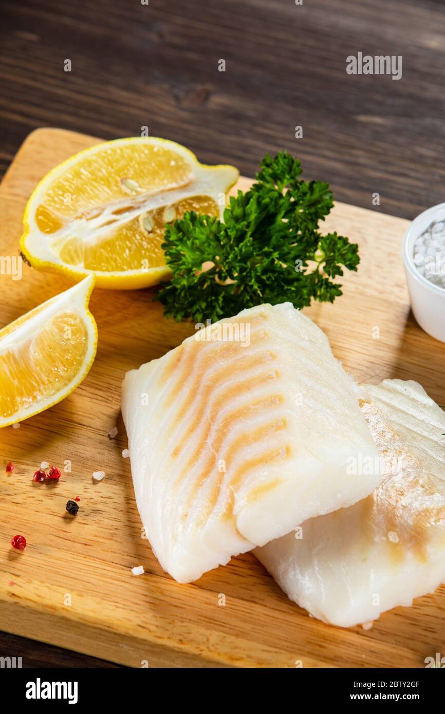 Fresh raw cod on wooden board Stock Photo - Alamy