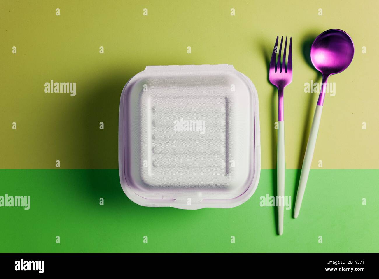 Healthy food concept: white burguer packaging closed with retro fork and spoon Stock Photo