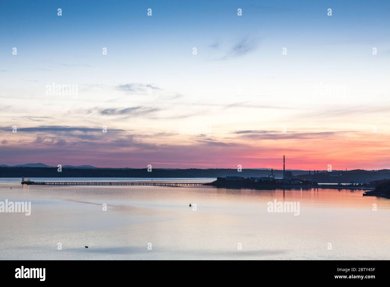 Whitegate, Cork, Ireland. 28th May, 2020.  Dawn over the oil refinery storage tanks and the ESB generating station in Aghada, Co. Cork, Ireland. With high pressure over the country tempetures are expected to reach a high of 27 degrees celcius today.  - Credit; David Creedon / Alamy Live News Stock Photo