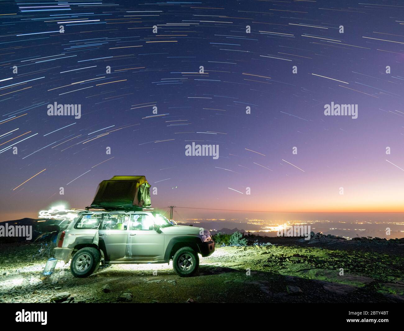 Star trails over truck camping site at Sharaf Al Alamayn, Sultanate of Oman, Middle East Stock Photo