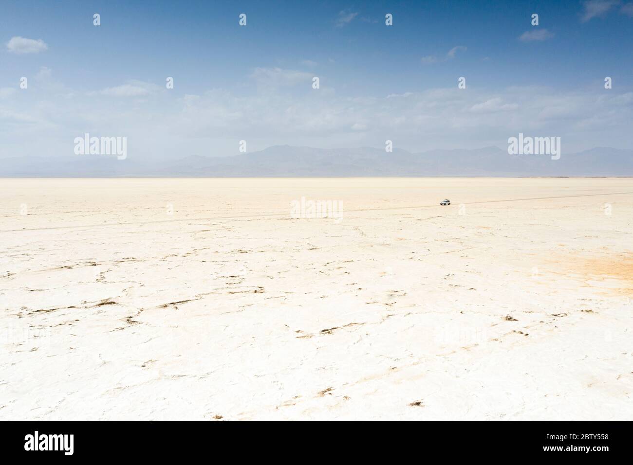 Off road vehicle crossing desert towards salt mines of Dallol, aerial view, Danakil Depression, Afar Region, Ethiopia, Africa Stock Photo