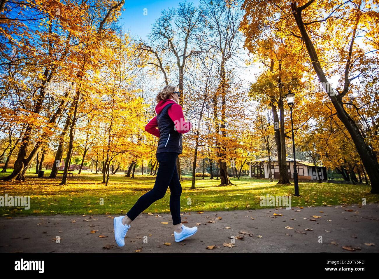 Healthy lifestyle - woman running in city park Stock Photo
